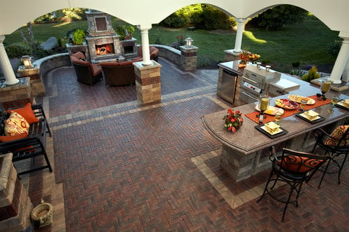 Outdoor kitchen with grill, countertop, and stone hardscaping.