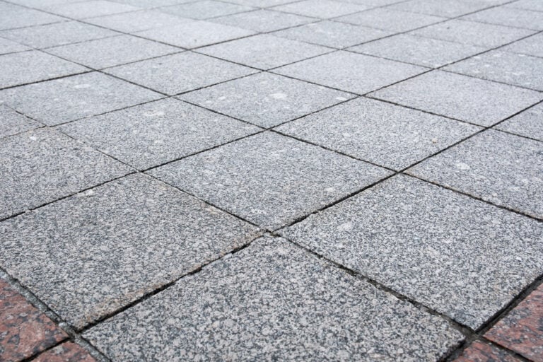 A close-up view of a beige stone with a rough, textured surface.