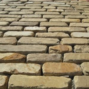 Cobblestone pavers arranged in a herringbone pattern.