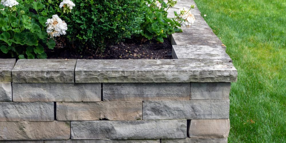 A,Natural,Stone,Retaining,Wall,With,Matching,Coping,Creates,A A Natural Stone Retaining Wall With Matching Coping